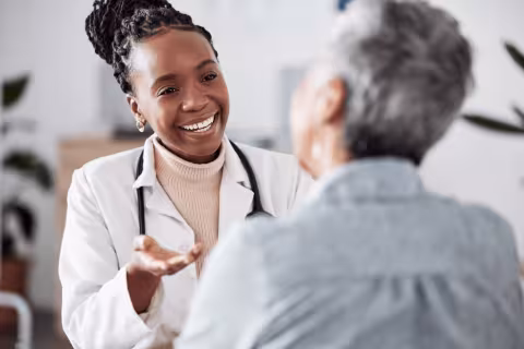 Doctor talking to an older patient in a medical office.