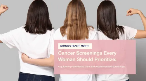 Three women standing together, one flexing her arm, all facing away.