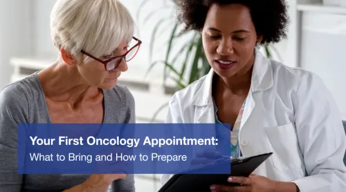 Doctor and patient discuss paperwork at a medical appointment.