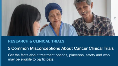 Three people talk together; one wears a headscarf and medical gown, others look supportive.